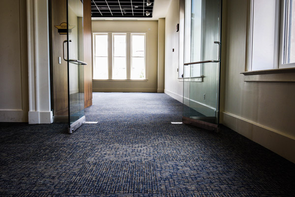 Carpet floor installation in a Houston suite corridor.