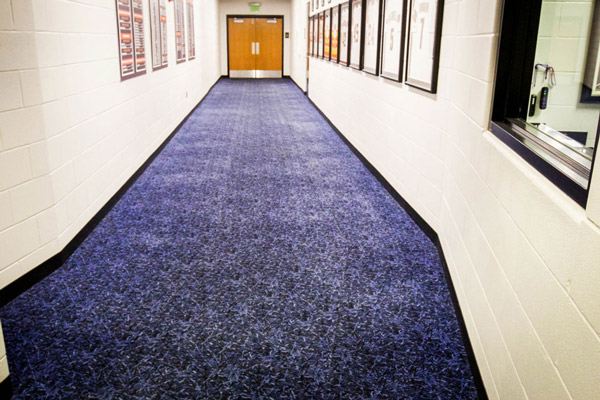 Carpet floor installation in a Houston corridor.